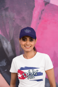 t-shirt-and-dat-hat-mockup-featuring-a-smiling-woman-posing-against-a-colorful-wall-m31904